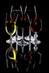Glasses of wine on a black background.