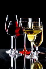 Glasses of wine on a black background.