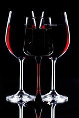 Red wine in a glass, on a black background.