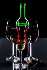 Red wine in a glass, on a black background.