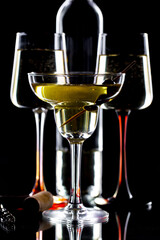 White wine in a glass, on a black background.
