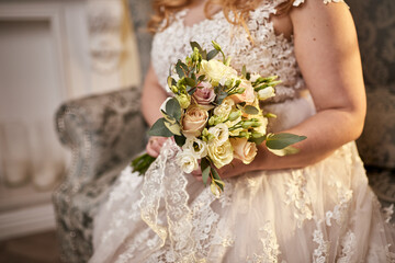 bouquet in hands of the bride, woman getting ready before wedding ceremony