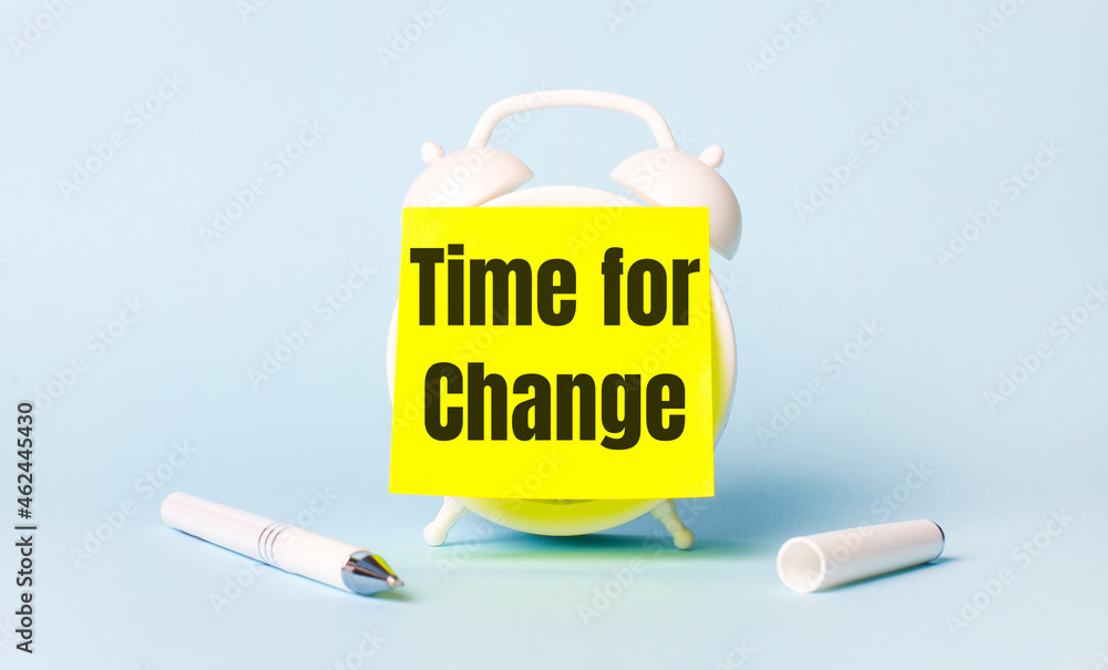Poster on a light blue background - a white handle and an alarm clock with a bright yellow sticker glued to