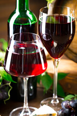 Wine in a glass, on an old background, with a bunch of grapes. Natural product.