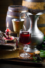 Wine glass with bottle and grapes on an old background.