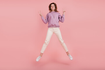 Fototapeta na wymiar Full length photo of mature attractive woman jumper fly show peace v-sign isolated pink color background