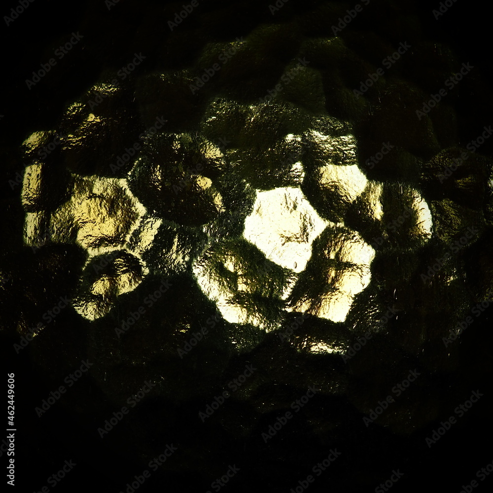 Poster corrugated glass, rear light source. play of glare and reflections on a transparent uneven surface. 