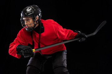 Cropped portrait of professional female hockey player training in special uniform with helmet...