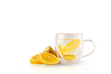 
Medicinal tea with lemon and ginger. Slices of lemon, ginger and a clear glass mug with tea.
