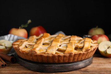 Delicious traditional apple pie on wooden table
