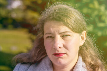 Fototapeta premium Portrait of a cheerful girl walking in the autumn park. close-up.