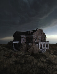 Ominous dilapidated and abandoned mansion on the prairie under a dark cloudy sky illuminated by...