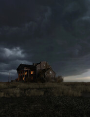 Ominous dilapidated and abandoned mansion with illuminated interior lighting under a dark cloudy...