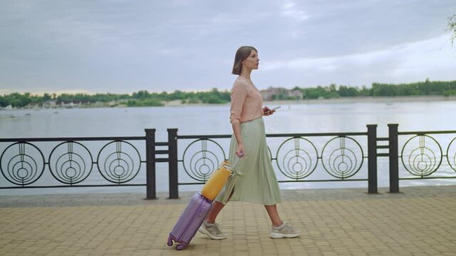 woman traveling walks with baggage