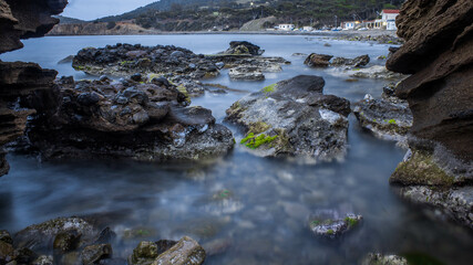 Fototapeta na wymiar beach of rocks at the sunset 