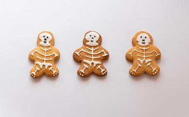 Various Halloween gingerbread cookies - skeletons on white background. Halloween concept. Top view.