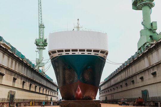 Front Prow of Large cargo ships Ship moored in floating dry dock yard during maintenance and repair in shipyard.