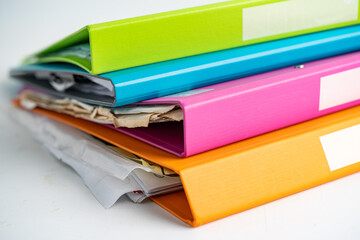 File Folder Binder stack of multi color on table in business office.