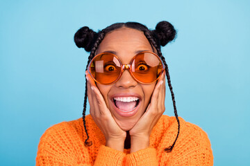 Photo of astonished young brunette lady hands face wear fall orange sweater eyewear isolated on...
