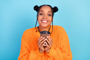 Photo of funny young brunette lady hold coffee wear orange sweater isolated on blue color background