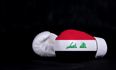 Boxing glove with Iraq flag on black background