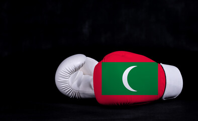 Boxing glove with Maldives flag on black background