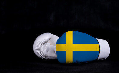 Boxing glove with Sweden flag on black background