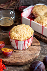 Plum cobbler on a wooden background.