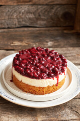 Cherry cake. Breton shortcrust pastry. Cheesecake. Cherry sauce. Side view. Wooden background.