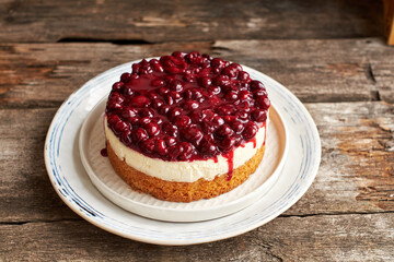 Cherry cake. Breton shortcrust pastry. Cheesecake. Cherry sauce. Side view. Wooden background.