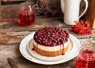 Cherry cake. Breton shortcrust pastry. Cheesecake. Cherry sauce. Side view. Wooden background.