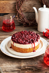 Cherry cake. Breton shortcrust pastry. Cheesecake. Cherry sauce. Side view. Wooden background.