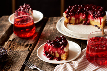Cherry cake. Breton shortcrust pastry. Cheesecake. Cherry sauce. Side view. Wooden background. Piece of cake