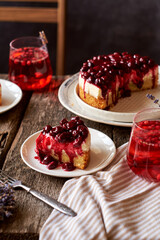 Cherry cake. Breton shortcrust pastry. Cheesecake. Cherry sauce. Side view. Wooden background. Piece of cake