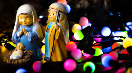 Background for Christmas. Bethlehem portal figures: Saint Joseph, Virgin Mary and baby Jesus with...