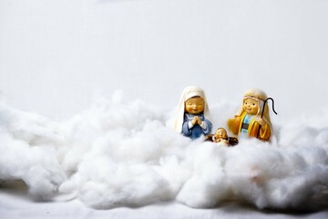 Figures of Portal de Belén on cotton simulating clouds. Christmas greeting concept. Copy Space