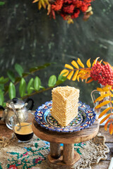 Piece of honey cake. Wooden background, side view. Layer cake.