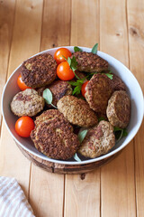 rissole on a wooden background decorated with sage.