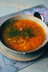 a traditional dish of Russian and Ukrainian cuisine, red borscht, with herbs and garlic