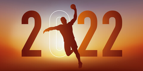 Concept du sport sur le thème du handball pour une carte de vœux 2022, montrant un handballeur qui s’élance pour marquer au but.