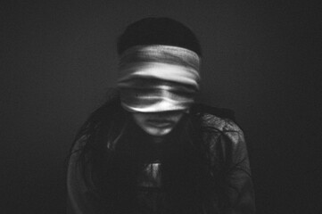 Portrait of creepy girl with bandages over her eyes