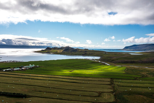 Sun hits a grass field on farmland in west Iceland.