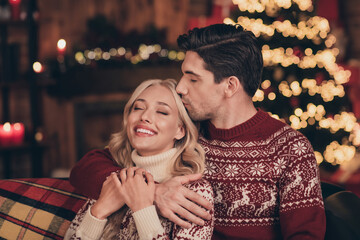 Portrait of two attractive cheerful life partners spending romance festal time day resting bonding kissing at decorated house indoors