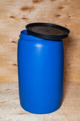 Plastic barrel stands on wooden background