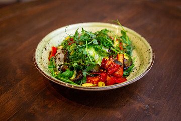 Healthy vegetable salad of fresh tomato, cucumber, onion, spinach, lettuce and sesame on plate. Diet menu.