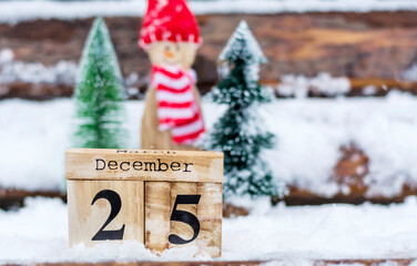 Merry Christmas greeting card with wooden calendar with 25 December date