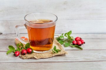 Rosehip tea on a wooden background 