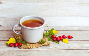 Rosehip tea on a wooden background 