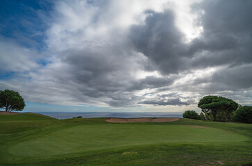 Green nr. 18 with clouds and see at Palheiro golf course on Madeira, Atlantic ocean, Portugal