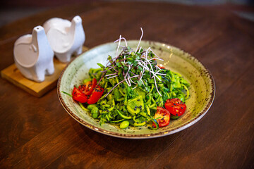 Healthy vegetable salad of fresh tomato, cucumber, onion, spinach, lettuce and sesame on plate. Diet menu.